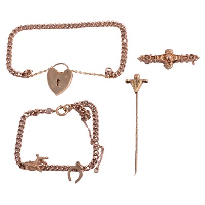 Lot 300 - Two curb link bracelets, two charms, a tie pin, and a broken brooch.