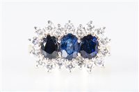 Lot 175 - A sapphire and diamond cluster ring, three...