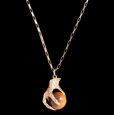 Lot 257A - A tigers eye pendant and chain.