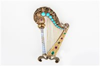 Lot 187 - A gemset harp brooch, the yellow metal...