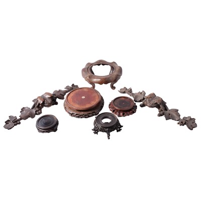 Lot 69 - Two carved wood appliques, and a collection of Oriental wooden stands