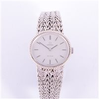 Lot 230 - Omega - A lady's bracelet watch, oval white...