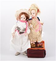 Lot 1421 - Two modern bisque head dolls, one with broken...