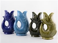 Lot 282 - Four Dartmouth Pottery Gurgling fish jugs for...