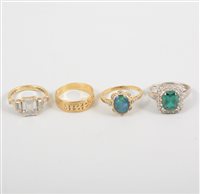 Lot 447 - Four dress rings, an 18 carat yellow gold...