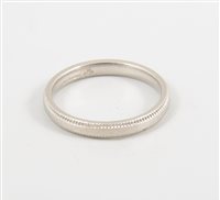 Lot 449 - A platinum wedding band, 3mm wide plain band...