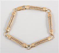 Lot 455 - A 9 carat yellow gold bracelet, five 30mm long...