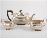 Lot 525 - A silver three piece teaset, plain rectangular...