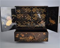 Lot 80 - A Japanese lacquered table cabinet, perhaps...