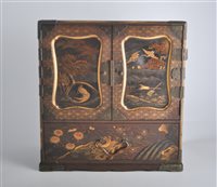 Lot 80 - A Japanese lacquered table cabinet, perhaps...