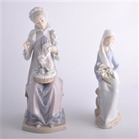 Lot 114 - Two Lladro figures, a girl seated with lilies...