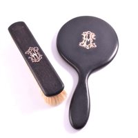 Lot 318 - Ebony hand mirror and clothes brush, with...