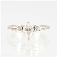 Lot 24 - A diamond solitaire ring, the pear shaped...