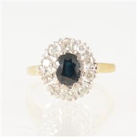 Lot 39 - A sapphire and diamond oval cluster ring, the...