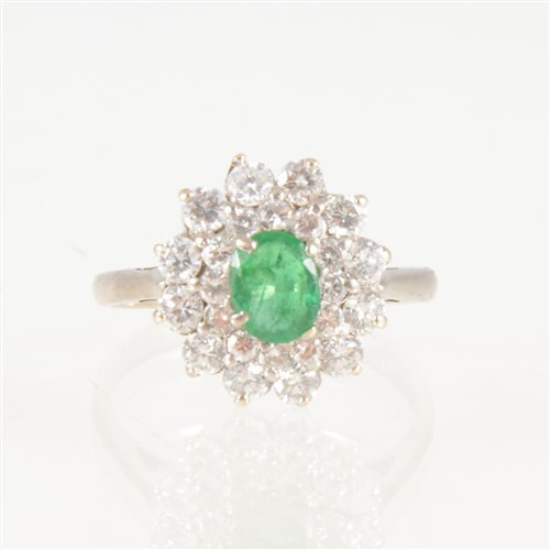 Lot 41 - An emerald and diamond oval cluster ring, the...