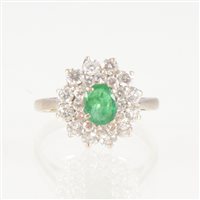 Lot 41 - An emerald and diamond oval cluster ring, the...