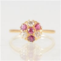 Lot 48 - A ruby and diamond circular cluster ring, four...