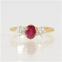 Lot 49 - A ruby and diamond three stone ring, the oval...