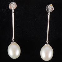 Lot 59 - A pair of pearl drop earrings, the 9mm x 11mm...