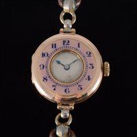 Lot 101 - A lady's vintage gold wrist watch with enamel...