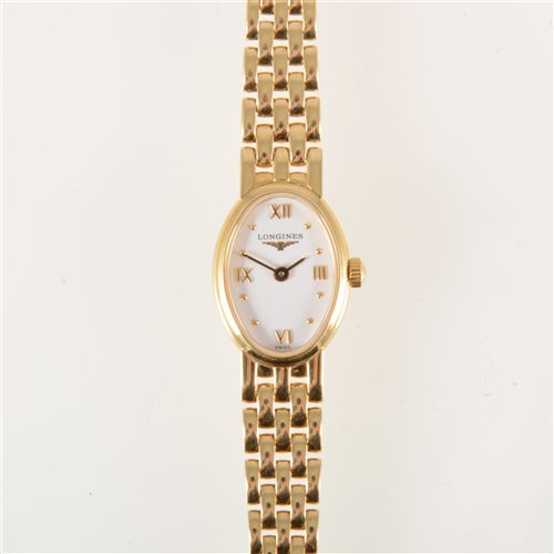 Lot 104 - Longines - A lady's bracelet watch, oval white...