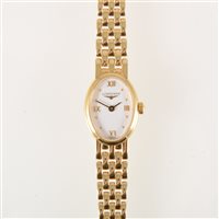 Lot 104 - Longines - A lady's bracelet watch, oval white...