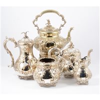 Lot 162 - Later Victorian silver-plated five-piece tea...