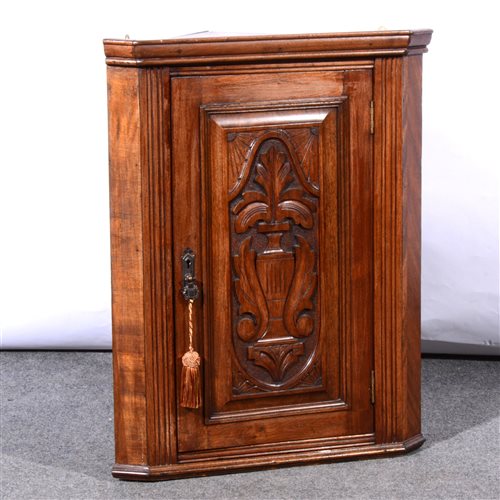 Lot 503 - Walnut hanging corner cupboard, carved panel.