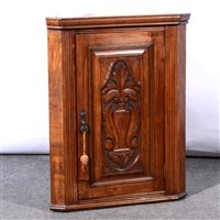 Lot 503 - Walnut hanging corner cupboard, carved panel...