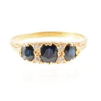 Lot 265 - A sapphire three stone ring, the oval mixed...