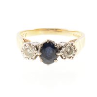 Lot 266 - A sapphire and diamond three stone ring, the...