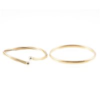 Lot 299 - Two modern yellow metal bangles, a 9 carat...