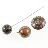 Lot 275 - Pique ware, a 25mm spherical hat pin decorated...