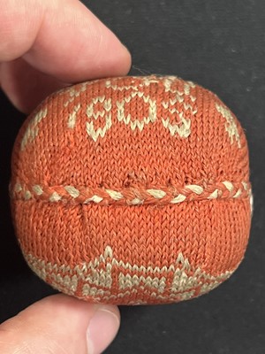 Lot 146 - A small needlework pin cushion, and another