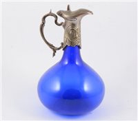 Lot 57 - White metal mounted claret jug, with blown blue...