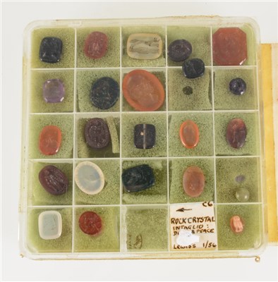 Lot 216 - A collection of 24 small intaglios in various stones including carnelian, amethyst and agate and depicting various figures and animals, some with a motto