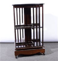 Lot 403 - Edwardian mahogany revolving bookcase, serpentine top...