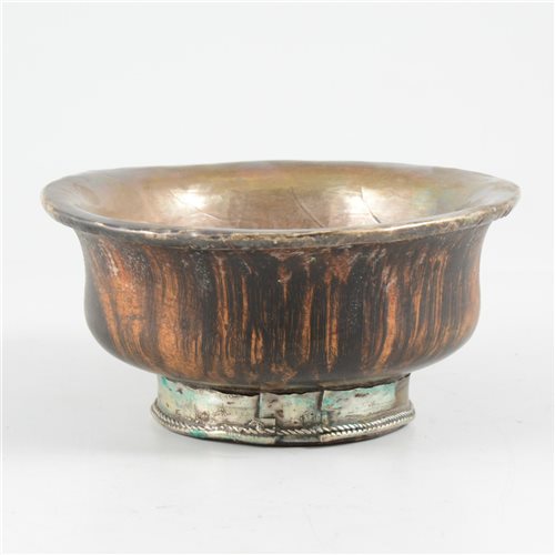 Lot 65 - Tibetan turned wood bowl, with white metal lining and foot-rim.