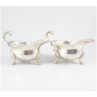 Lot 99 - Pair of George II style silver sauceboats, Pearce & Sons, London, 1930.