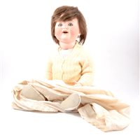 Lot 224 - Bisque head character doll, composition body, together with a Victorian stained beechwood turned rocking chair. (2)