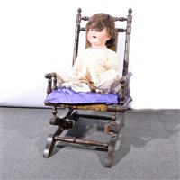 Lot 224 - Bisque head character doll, composition body, together with a Victorian stained beechwood turned rocking chair. (2)