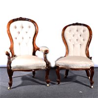 Lot 489 - Victorian walnut framed armchair, a watered brocade style upholstery, carved cresting, scrolled arms, French cabriole legs, width 70cm; and a nursing chair, upholstered ensuite, (2).