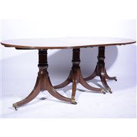 Lot 537 - George III style mahogany three-pillar dining table