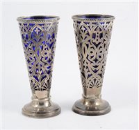 Lot 291 - Pair of pierced silver tapering vases, with blue glass liners