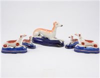 Lot 10 - Two pairs of Staffordshire miniature reclining dog pen stands, and a larger fifth stand (5)