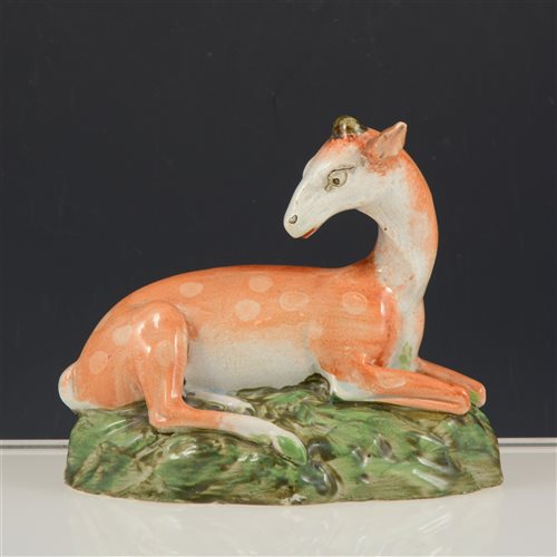 Lot 14 - Staffordshire lead glazed earthenware figure of a recumbent deer, 14cm.