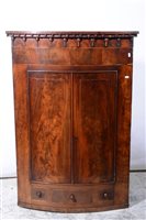 Lot 418 - A William IV mahogany cylinder front corner cupboard.