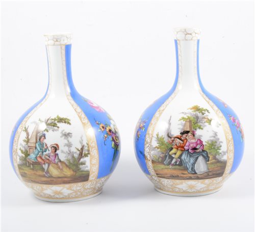 Lot 25 - A pair of Dresden bottle vases, blue and white ground panels alternating with decoration of a courting couple and flowers, marked AR, 24cm.