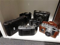 Lot 131 - A collection of cameras, a press camera, Canon, Zorko etc (7).