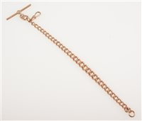 Lot 254 - A 9 carat rose gold bracelet, originally part of a watch chain, solid graduated curb links, fitted with a T bar and swivel, 20cm long, approximate weight 26.5gms